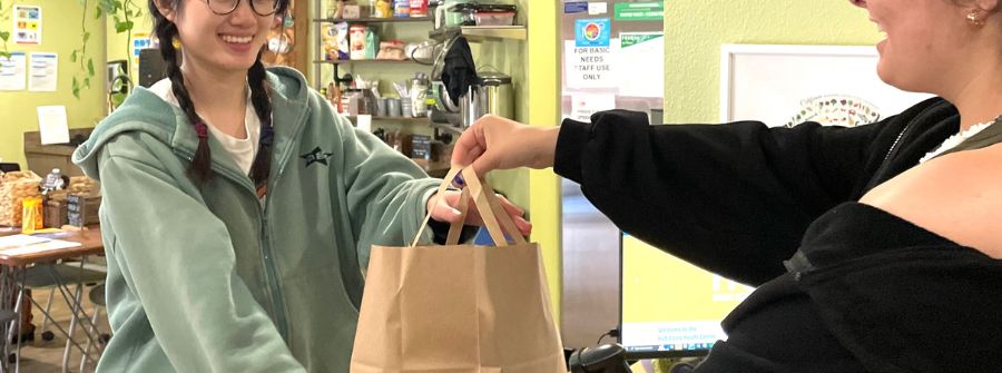 Bag with personal hygiene products being handed to a student
